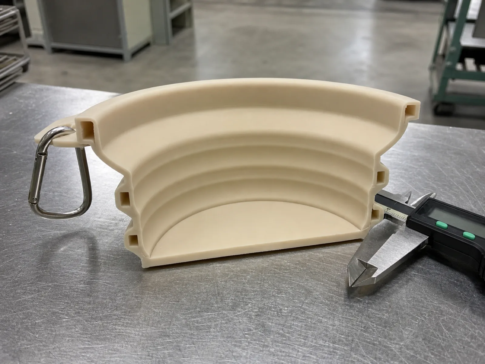 Engineering cross-section of a collapsible silicone pet bowl showing three accordion ribs at 2.2 mm wall thickness, 10 mm rib pitch, base plate, rim loop for carabiner, and a durometer 60 Shore A body at a Dongguan silicone factory.