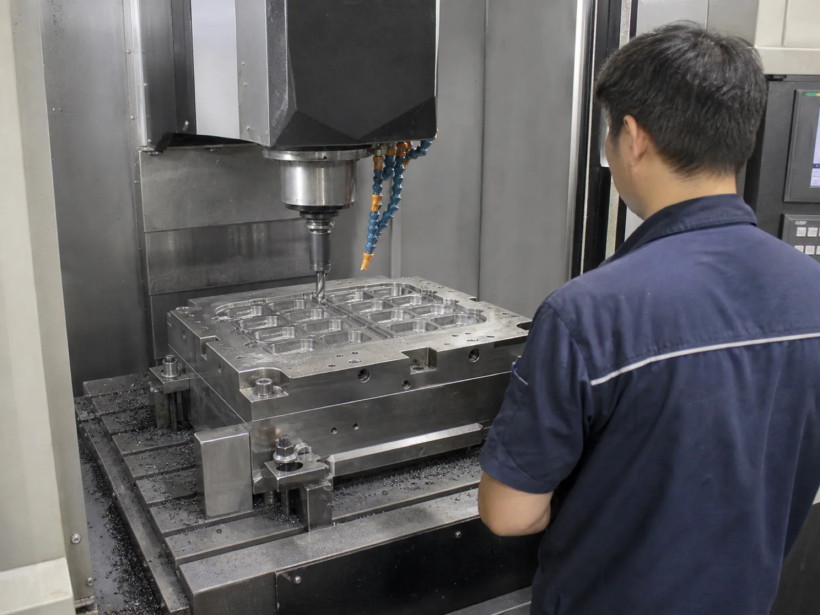 Wetop Silicone in-house mold-making CNC machining a P20 steel multi-cavity mold for a custom silicone ice tray program with the floor operator monitoring the spindle in Dongguan