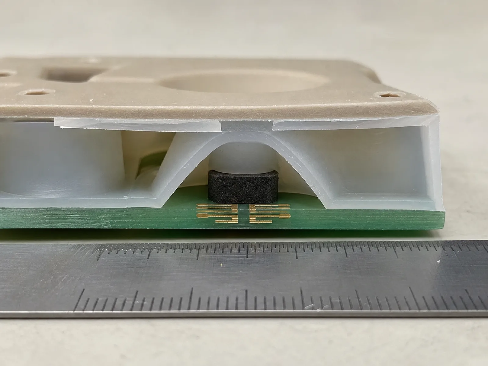 Cross-section engineering diagram of a compression-molded silicone keypad showing key dome, web-wall diaphragm, carbon-pill conductive contact, PU top coat, and PCB substrate on Wetop QC bench