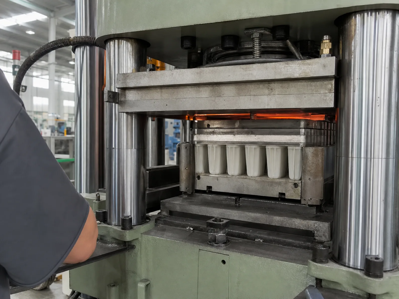 Wetop Silicone compression molding press mid-cycle curing a 6-cavity platinum-cure silicone popsicle mold at 180°C under hydraulic clamp in Dongguan