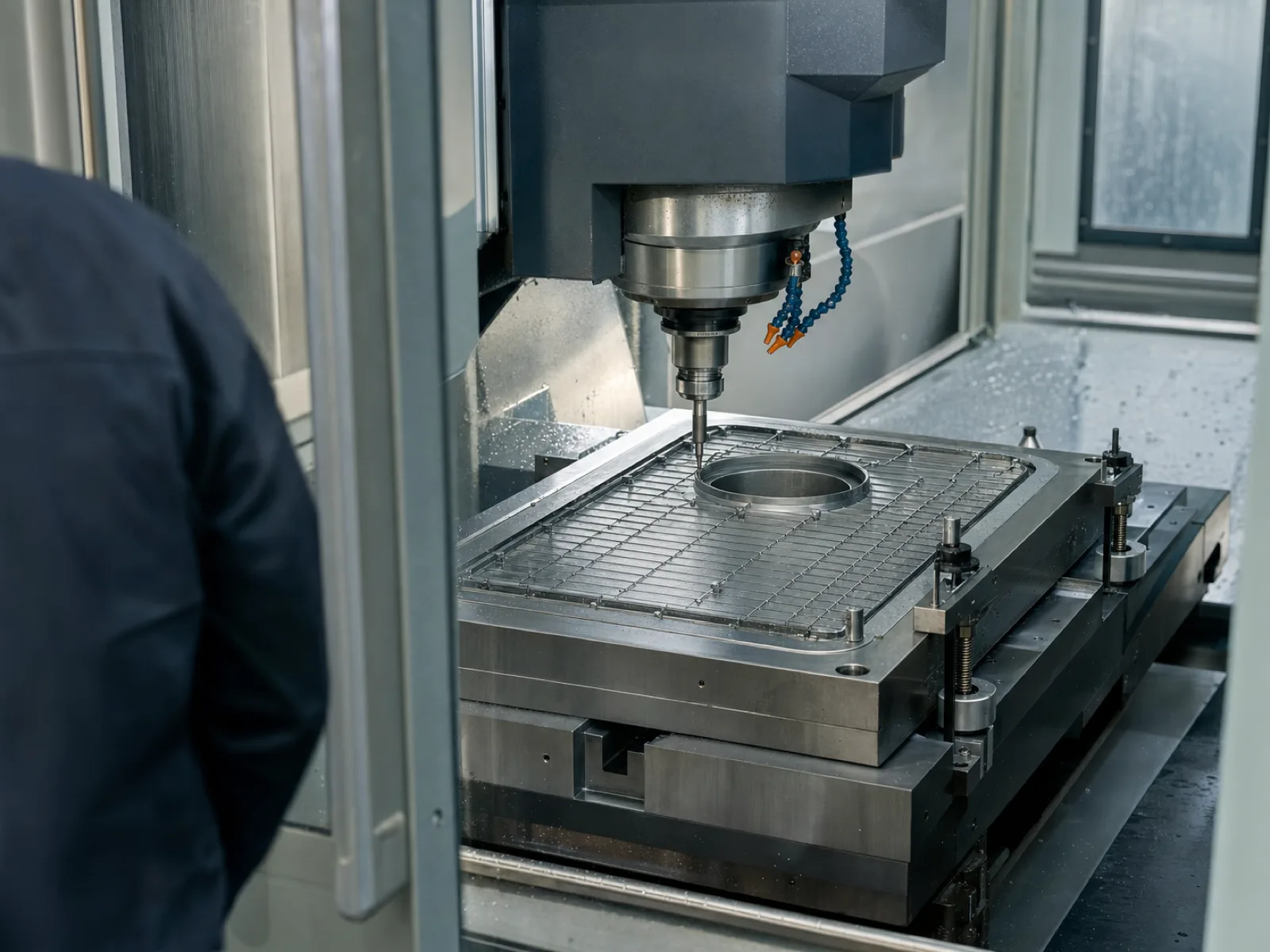 Wetop Silicone in-house mold workshop with a 5-axis CNC cutting a P20 hardened steel mold for a silicone sink grid — the tooling that must precisely match the sink OEM current-production drain cutout position